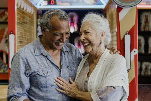 Reverse Mortgage - Happy elderly couple on beach